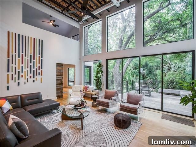 Spacious living area with high ceilings, hardwood floors, and large windows.