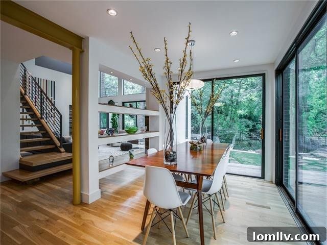 Modern interior showcasing high ceilings and an elegant open-tread staircase.