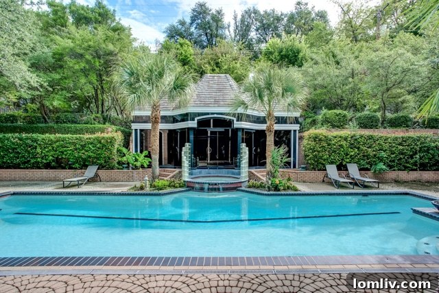 Luxurious living room overlooking the pool and cabana at 2201 Hidden Creek Road in Westover Hills.