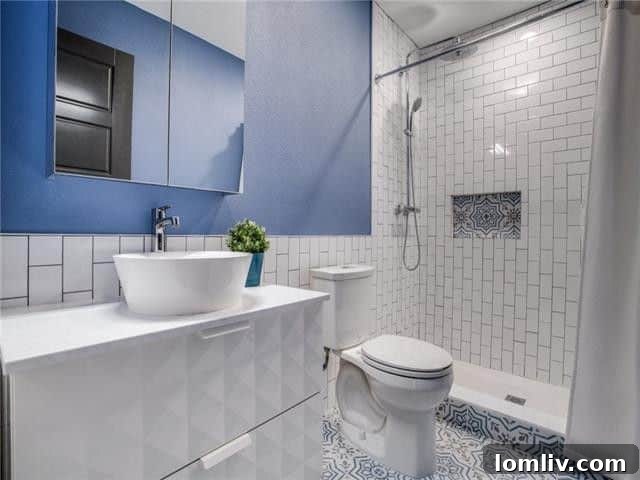Beautifully renovated bathroom featuring subway tile, a stylish contemporary vanity, and modern fixtures