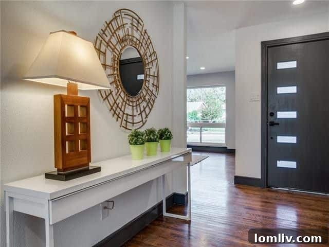 Bright and inviting living area featuring newly refinished hardwood floors and ample natural light