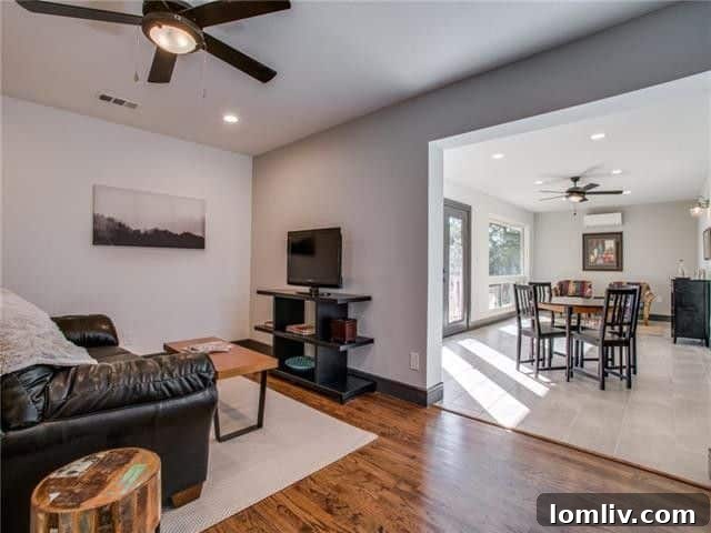 A glimpse into the open-concept living room, showcasing the fresh paint and contemporary design choices