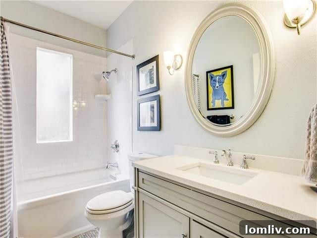 Updated second full bathroom with modern tiling and fixtures.