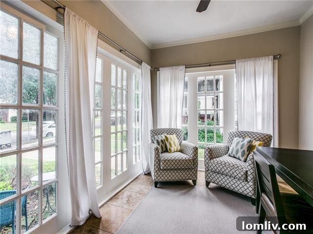 Open concept living and dining area with gleaming hardwood floors and French doors.