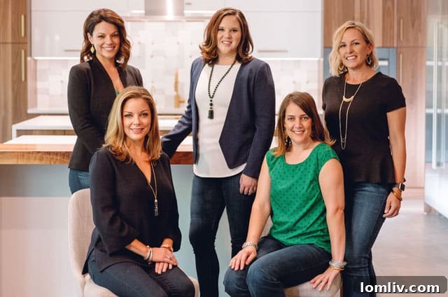 The Heather Guild Group team standing together, celebrating their move to Compass Real Estate. Pictured are Haley Wagstaff, Valerie Caddell, Kelly Taylor, Heather Guild, and Amy Sack, embodying a dynamic and client-focused real estate collective.