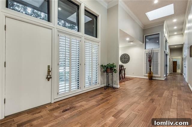 Spacious living room with natural light and hardwood floors