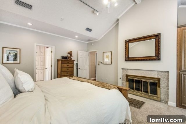 Luxurious master bedroom with fireplace and elegant decor