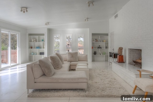 All-white minimalist fireplace with no mantel at 4013 Clayton Road, a challenge for Santa's stockings