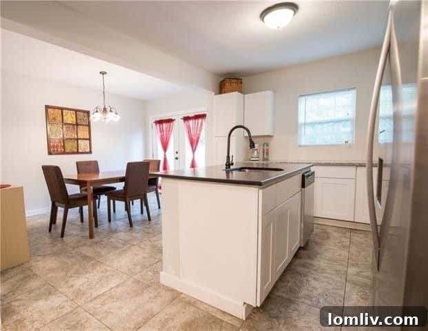 Spacious kitchen with large island and granite countertops in Dallas cottage