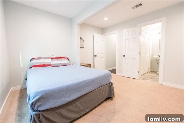 Bright master bedroom with seating area in Oak Cliff renovation