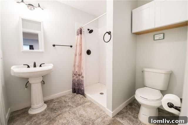 Stylish master bathroom with modern fixtures and ample light
