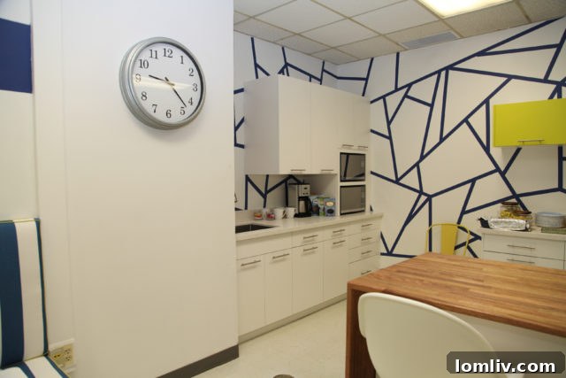 After renovation: The bright and modern serving area in the Merriman Park Elementary teachers' lounge, featuring new countertops and cabinetry.