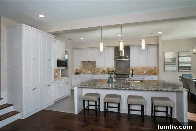 Sleek gourmet kitchen with a large island, stainless steel appliances, and ample counter space