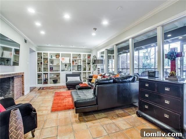 Bright and spacious living room with floor-to-ceiling windows, built-in bookshelves, and a fireplace
