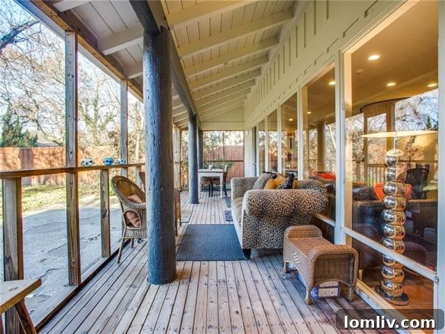 Cozy screened-in porch with seating, overlooking a private landscaped backyard in Dallas