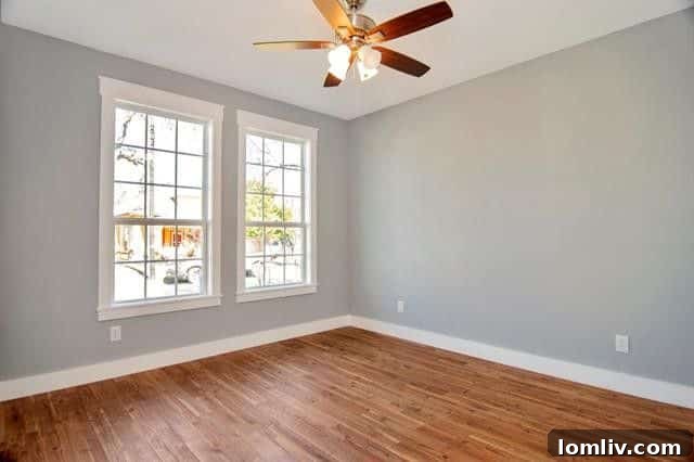 Inviting guest bedroom with ample space and natural light, reflecting the home's comfortable and stylish aesthetic