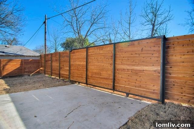 Lush green lawn within the fenced backyard, suggesting potential for gardening or a perfect play area for pets and children