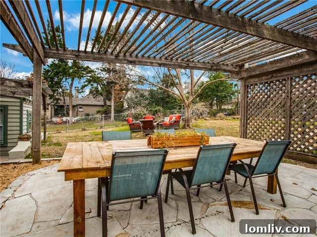 East Kessler Cottage: A Captivating Charmer 11 Serene view of the large backyard with ample space for outdoor activities
