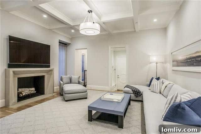 A cozy sitting area off the kitchen, absolute genius for informal gatherings, featuring a door to the garage and staircase to the lower level. An elevator provides convenient access. Note the subtle design changes from earlier photos.