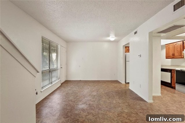 Well-lit living room and generous kitchen in Turtle Creek Terrace Unit #168, showcasing smart use of space.