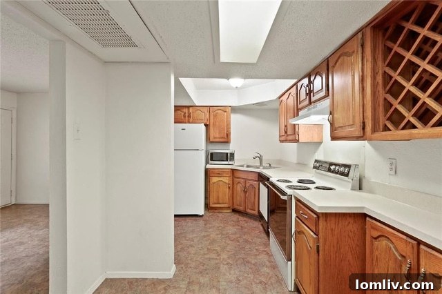 Spacious kitchen with ample counter space, cabinetry, and a wine rack inside the affordable Uptown Dallas condo.