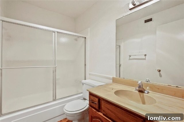 Functional master bathroom in Turtle Creek Terrace condo, offering potential for future upgrades.