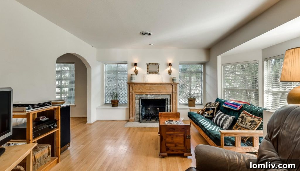 Bright and airy living room of the Old Lake Highlands home with light hardwood floors and a bay window.