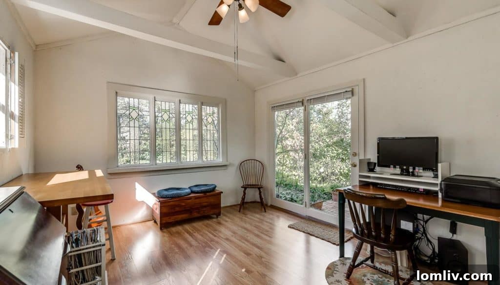 Bedroom with ample natural light, a ceiling fan, and hardwood floors in the Old Lake Highlands property.