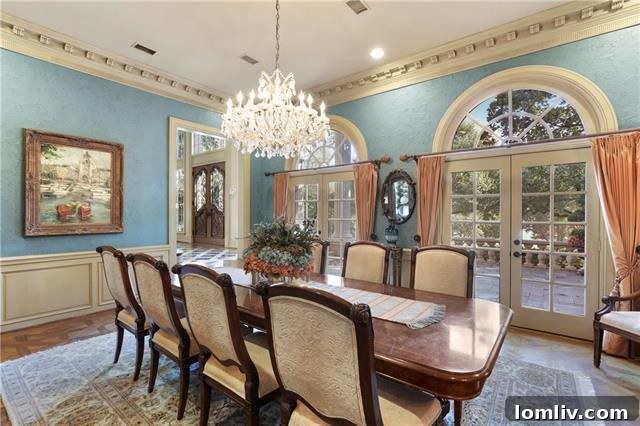 The elegant formal dining room with French doors opening to the front patio, offering scenic lake views and an inviting atmosphere for entertaining.