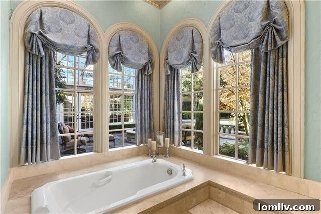 Another view of the master bathroom, highlighting a freestanding tub and elegant tiling, enhancing the luxurious feel.