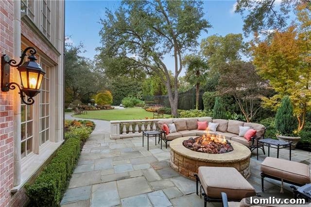Exterior shot featuring a patio or outdoor living area, perfect for entertaining with views of the expansive grounds.
