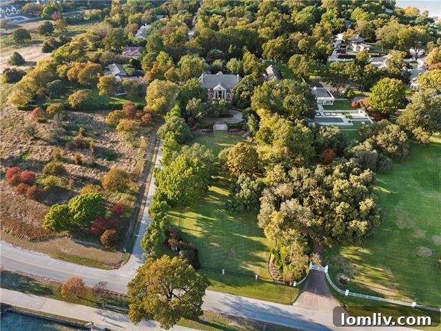 A vibrant aerial view showcasing the expansive green lawns and mature trees that define the two-acre estate.