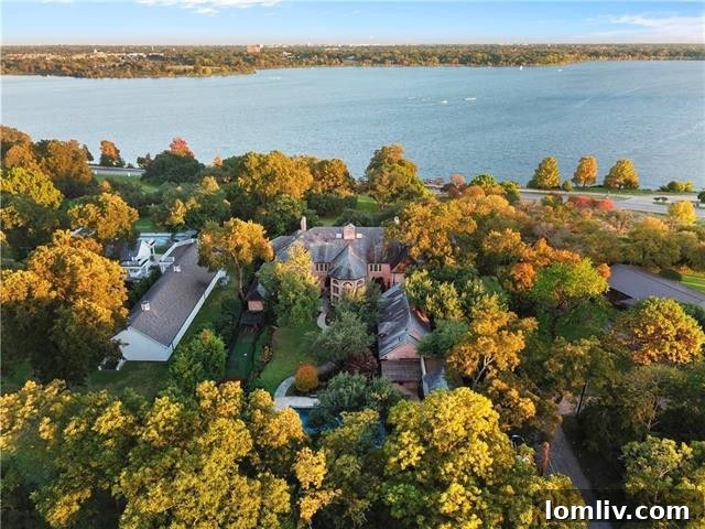 Panoramic view of the White Rock Lake estate's rear, highlighting its proximity to the lake and various outdoor amenities, including the guest quarters.