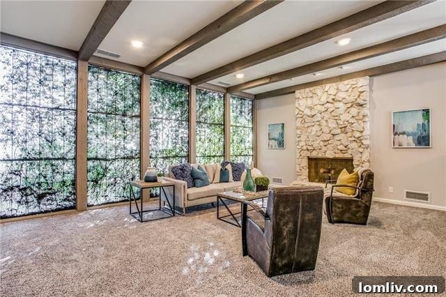 Spacious open concept living area with exposed beams and natural light