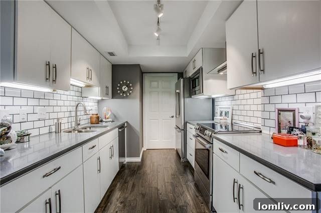 3621 Turtle Creek Blvd Apt 4L - Sophisticated living room featuring bold art, luxurious draperies, and rich hardwood floors.