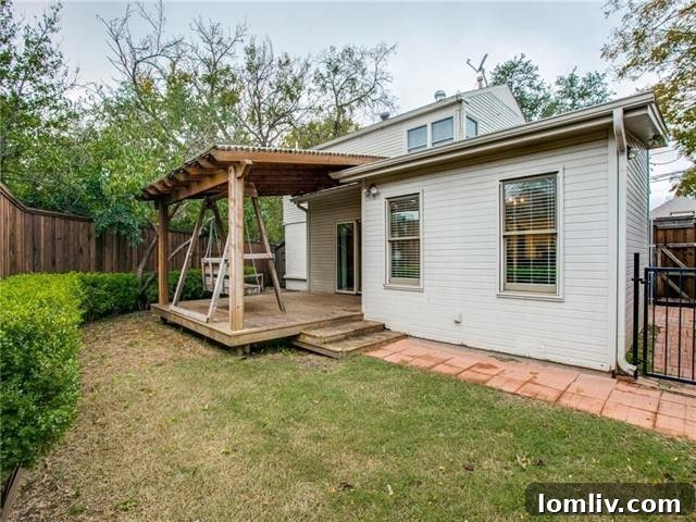 Charming low-maintenance backyard with a covered patio and swing