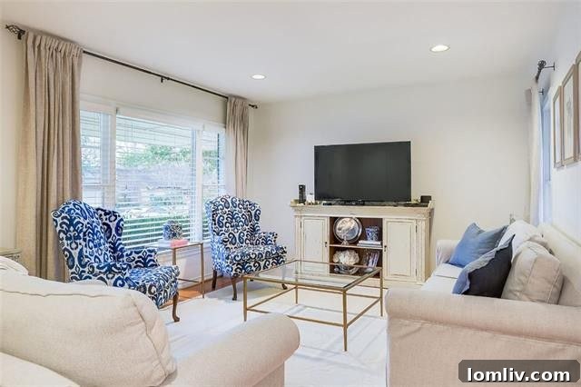 Spacious living area with hardwood floors, a fireplace, and ample natural light, ready for personalization.