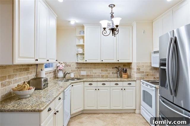 Modern kitchen with natural stone countertops and ample cabinet space, flowing into the dining area.