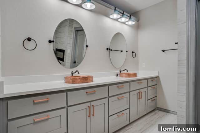 Elegant dual vanity with marble-look quartz countertops in the master bathroom
