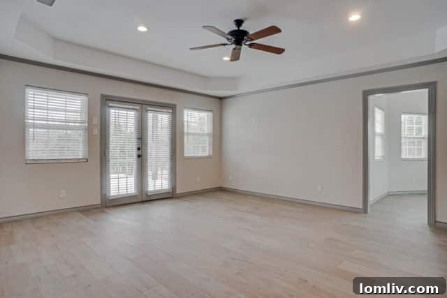 Spacious master bedroom with abundant natural light and elegant decor