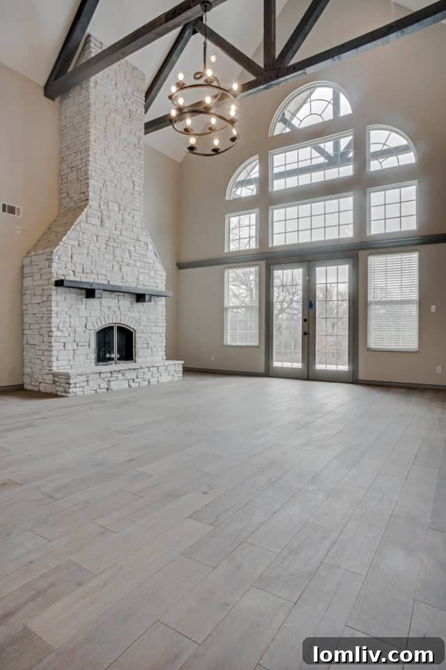 Grand living area with spiral chandelier and tall windows, renovated by Blackwood Homes