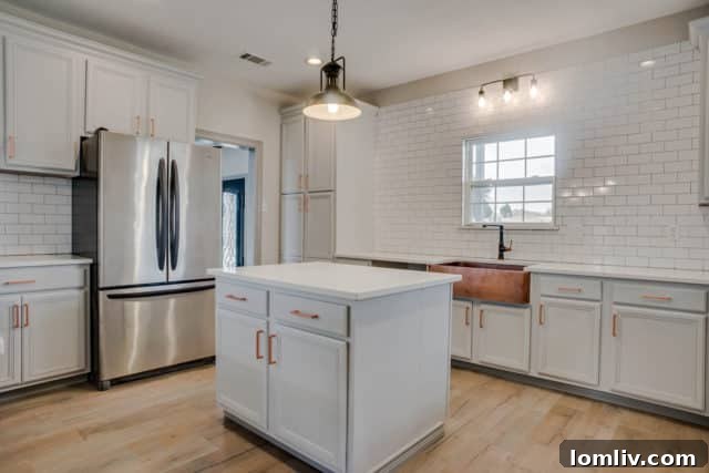 Modern kitchen with white cabinetry and large island, perfect for entertaining