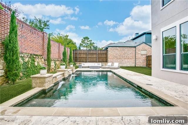 Resort-Style Pool Area with Water Features and Shaded Seating