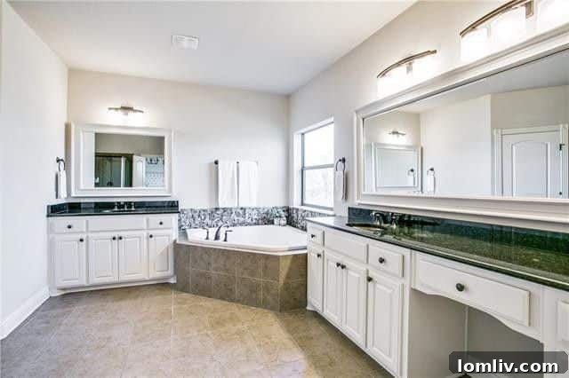 Master Bathroom with Dual Vanities, Corner Tub, and Walk-in Shower