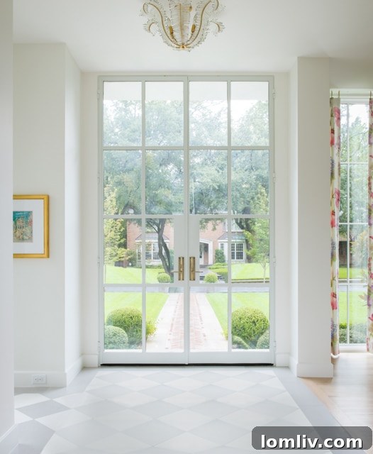 Honed limestone entry with custom steel front door in a luxury home.