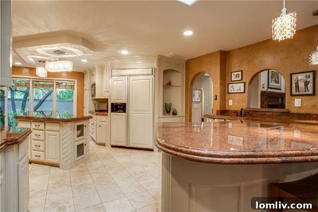 Gourmet kitchen with marble island, high-end appliances, and ample cabinetry