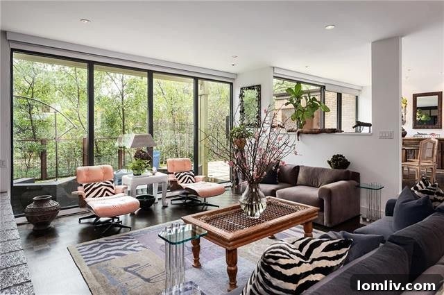 Large windows with automatic blinds in the Tealwood Square home