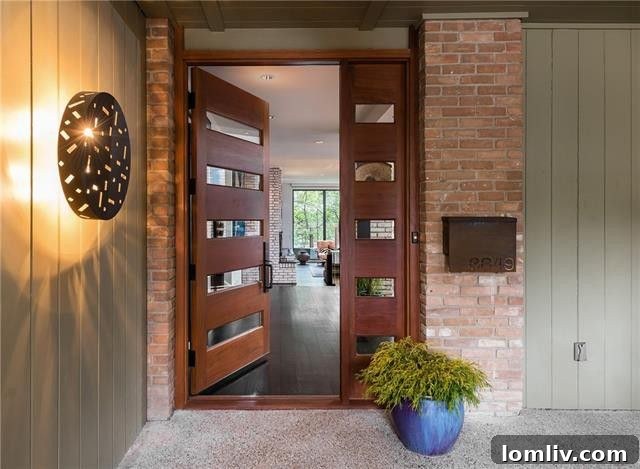 Spacious living room with floor-to-ceiling windows overlooking the creek in 8849 McCraw Drive