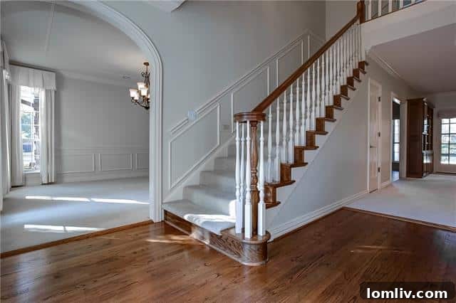 Live Large in Meadows West 3 Elegant entry hall with sweeping staircase in Fort Worth home