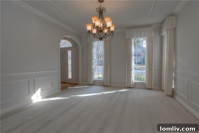 Live Large in Meadows West 4 Spacious formal living room with classic trim and monochrome decor